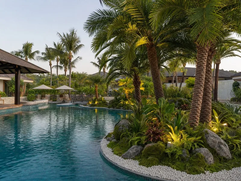 Artificial palms at a resort poolside